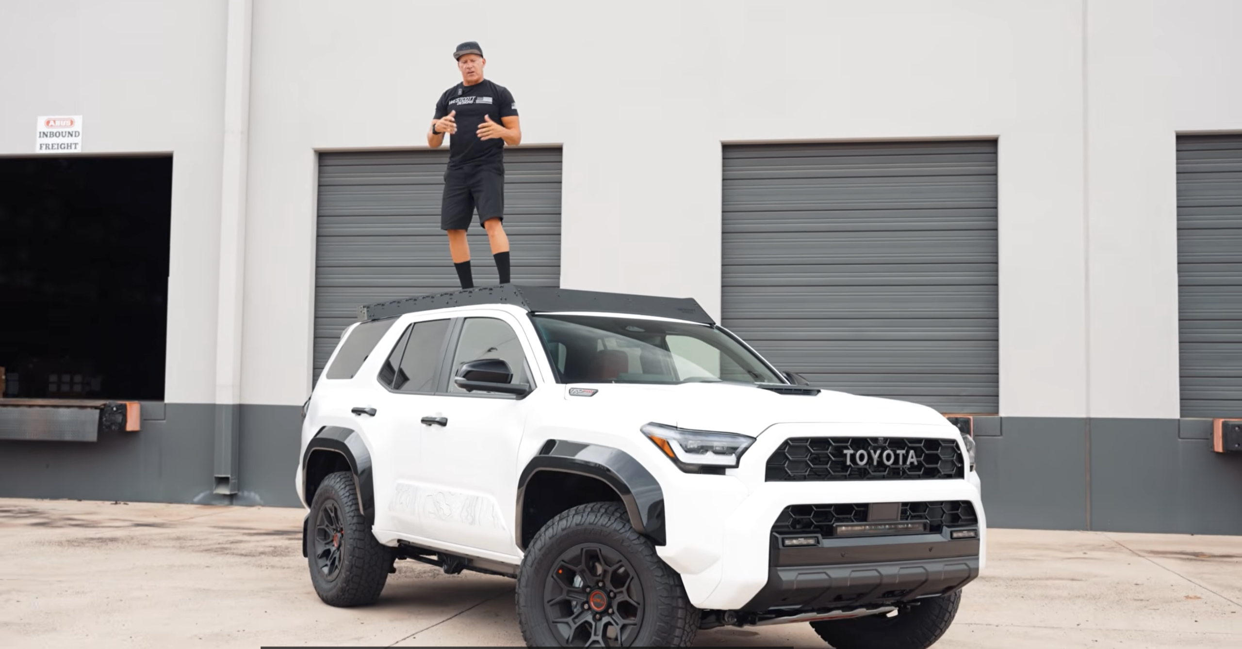 jeff westcott standing on the roof rack of a 4runner