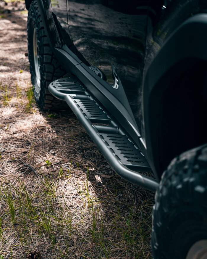 2024 Toyota Land Cruiser LC250 Westcott Designs Rock Sliders 0 Degree WithKick-Out with Top plates. Lifestyle from Black lc250 Passenger View