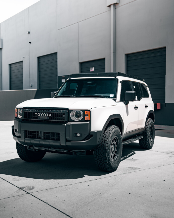 2024 Toyota Land Cruiser LC250 Westcott Designs Rock Sliders 0 Degree No Kick-Out with Top plates lifestyle from white lc250 Vehicle View